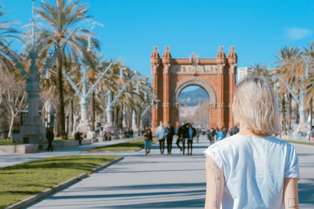 Woman walking towards an archway in Barcelona, Spain