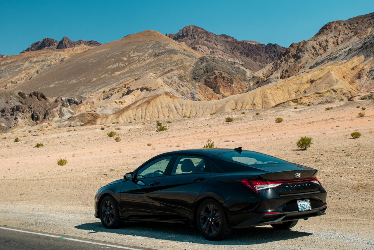 Black Hyundai Elantra on a road in the desert in Death Valley