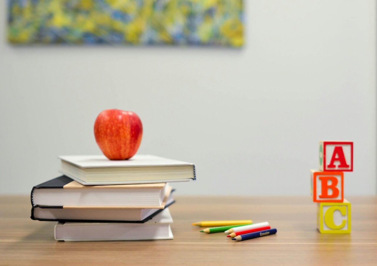 Books, apple and letters on a desk