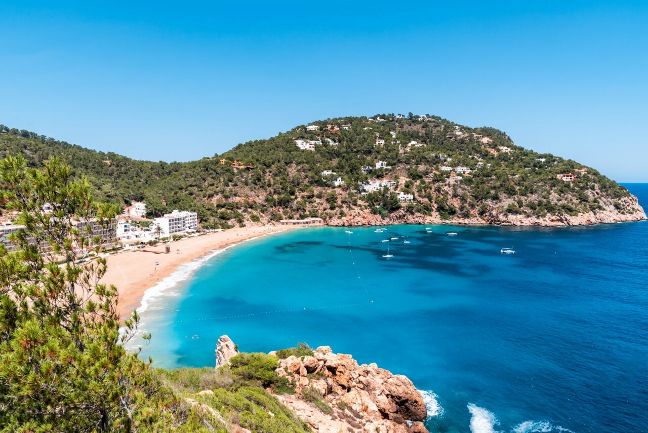 Beautiful sandy beach with blue water in Cala San Vincente Ibiza