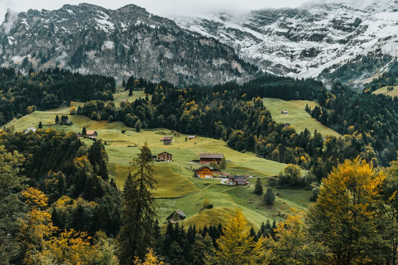 Green hills and snowy mountains in the Swiss Alps