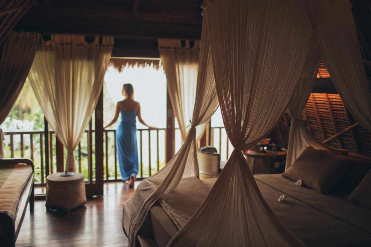 Woman standing on a balcony in a hotel room