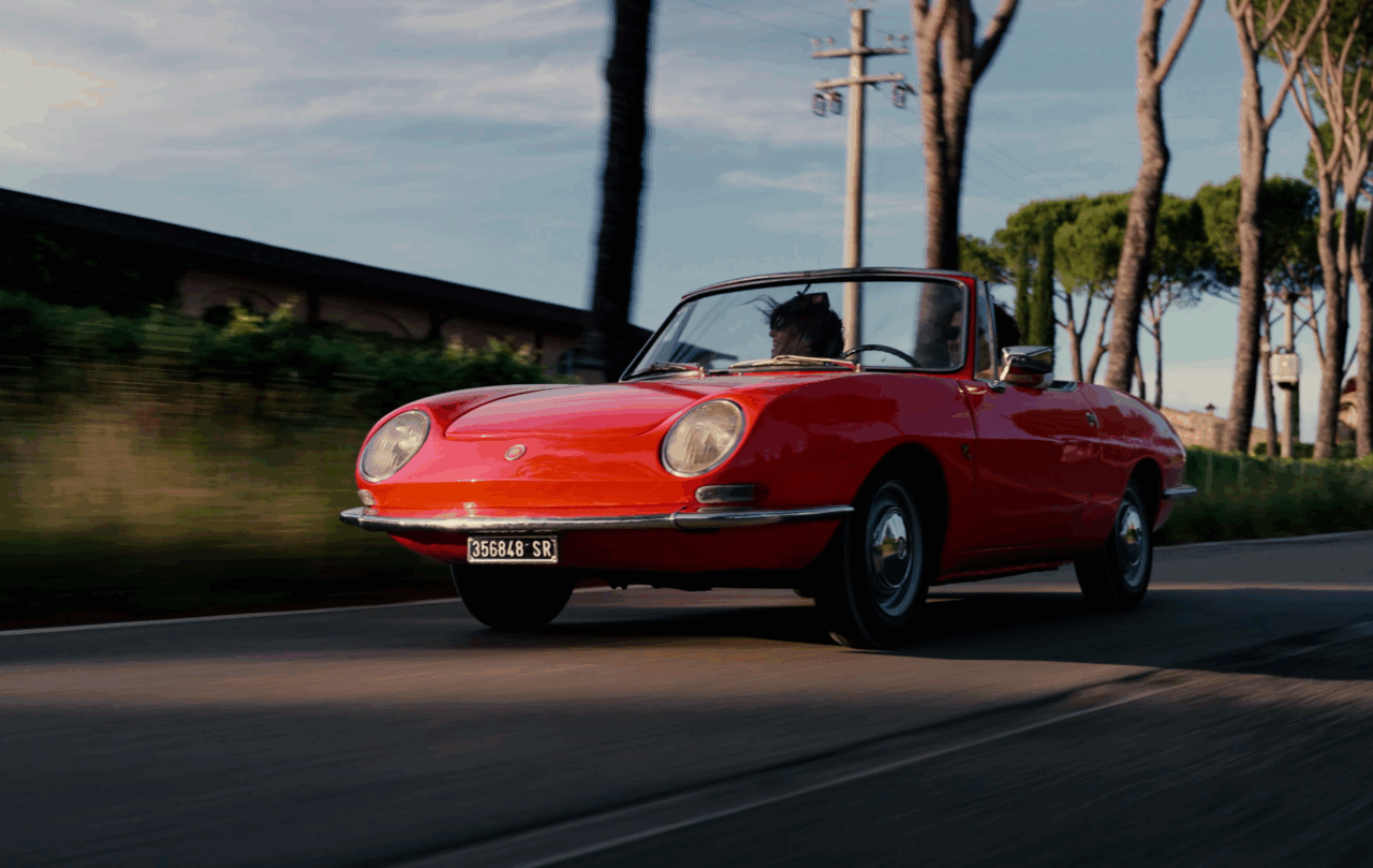Vintage Red car driving through Tuscany