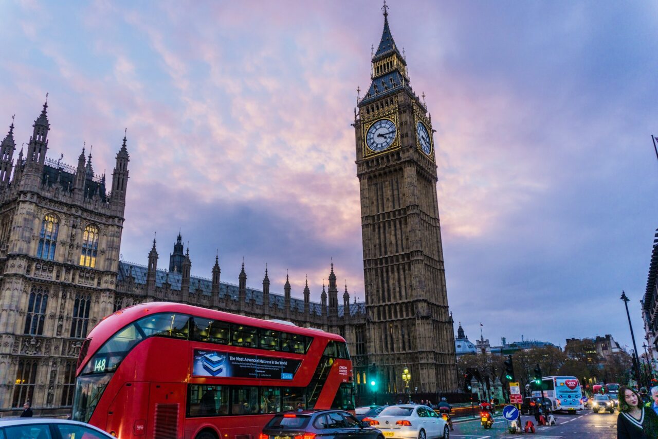 Big Ben and a red London bus at sunset