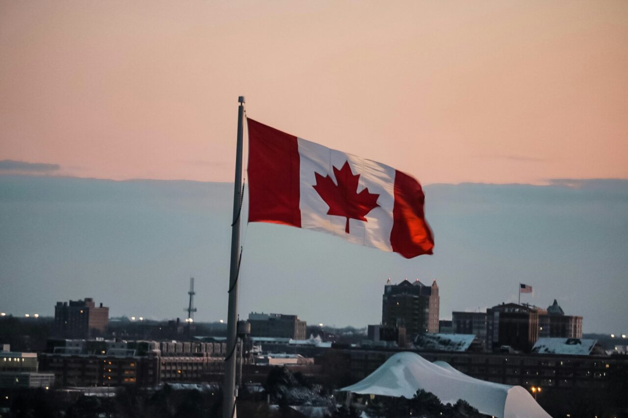 Canadian flag flying over a city