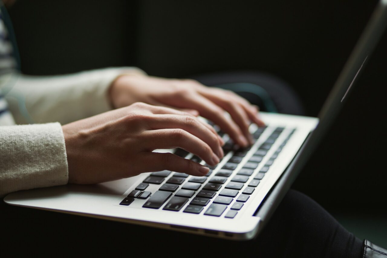 Close up of hands on a silver laptop