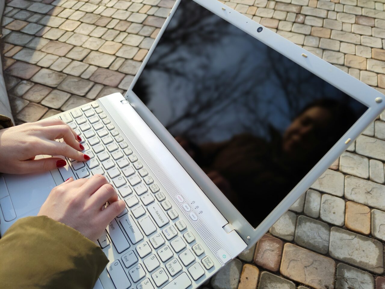 Close up of hands typing on a laptop