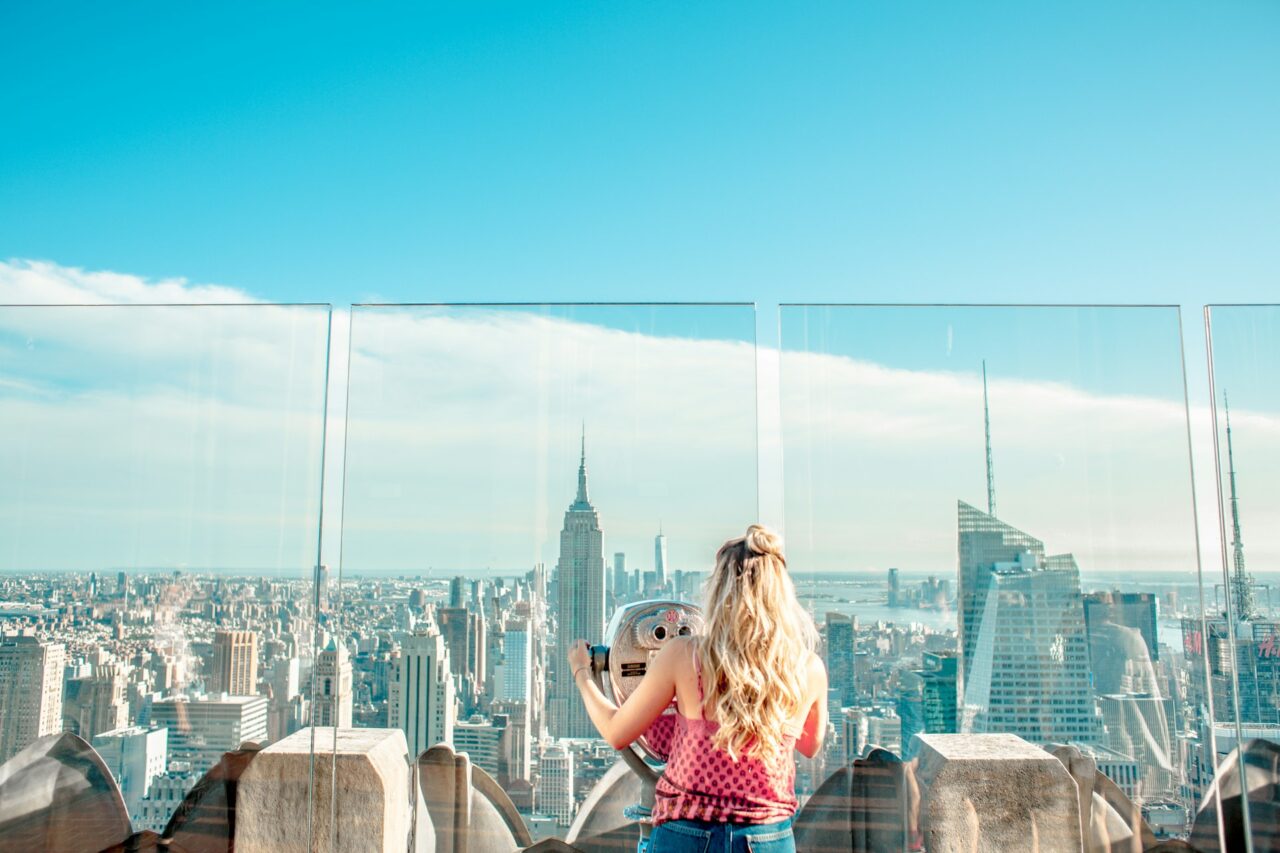 Girl at Top of The Rock looking out at the view of New York and the Empire State Building