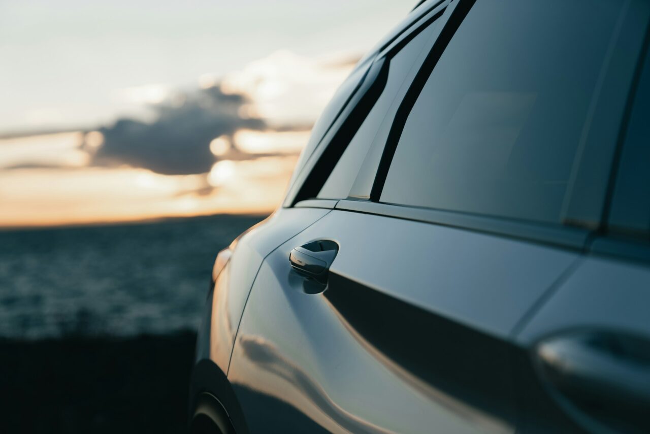 Close up of a parked car next to the ocean
