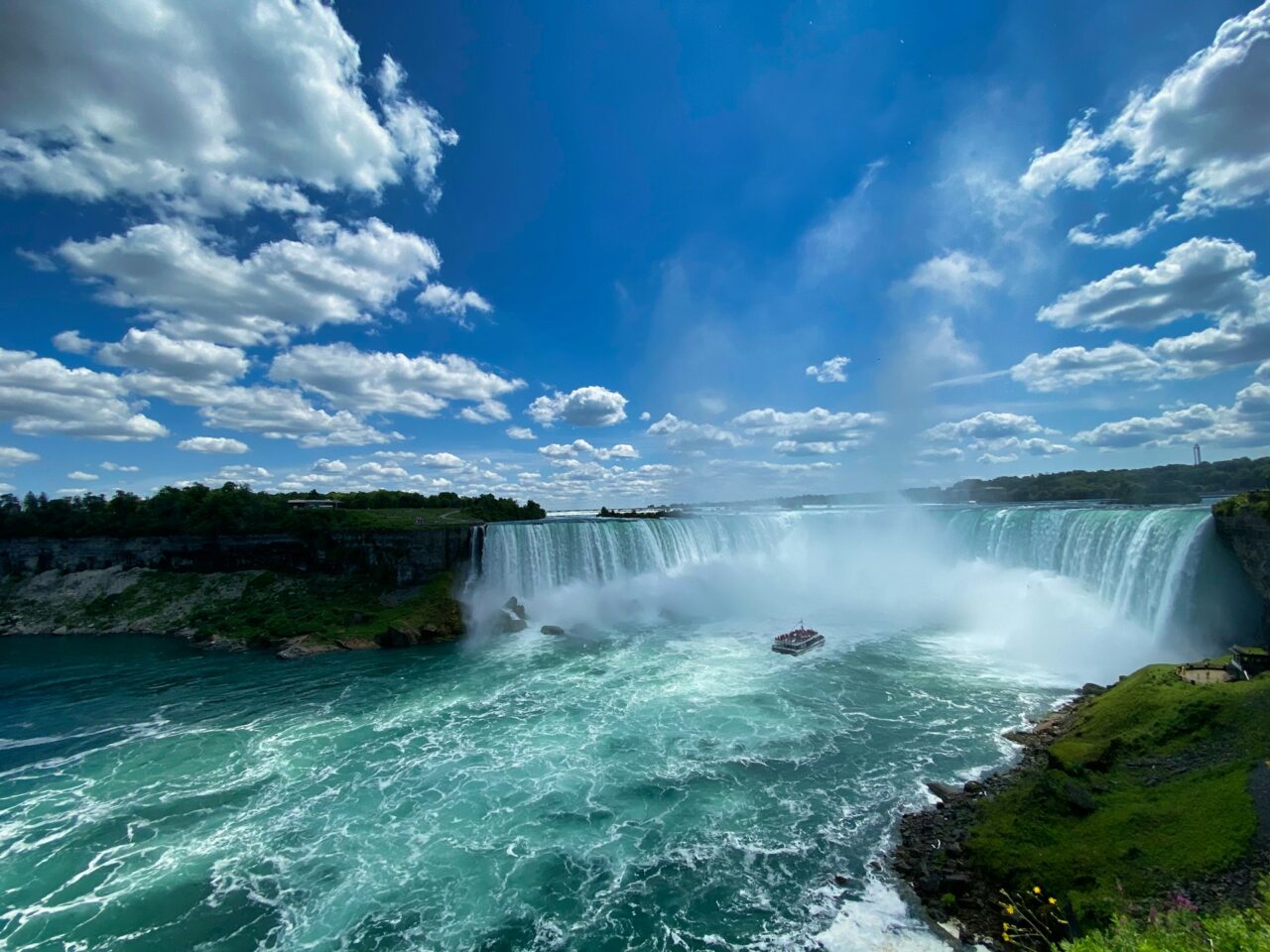 Niagara Falls on a sunny day with boat on the water