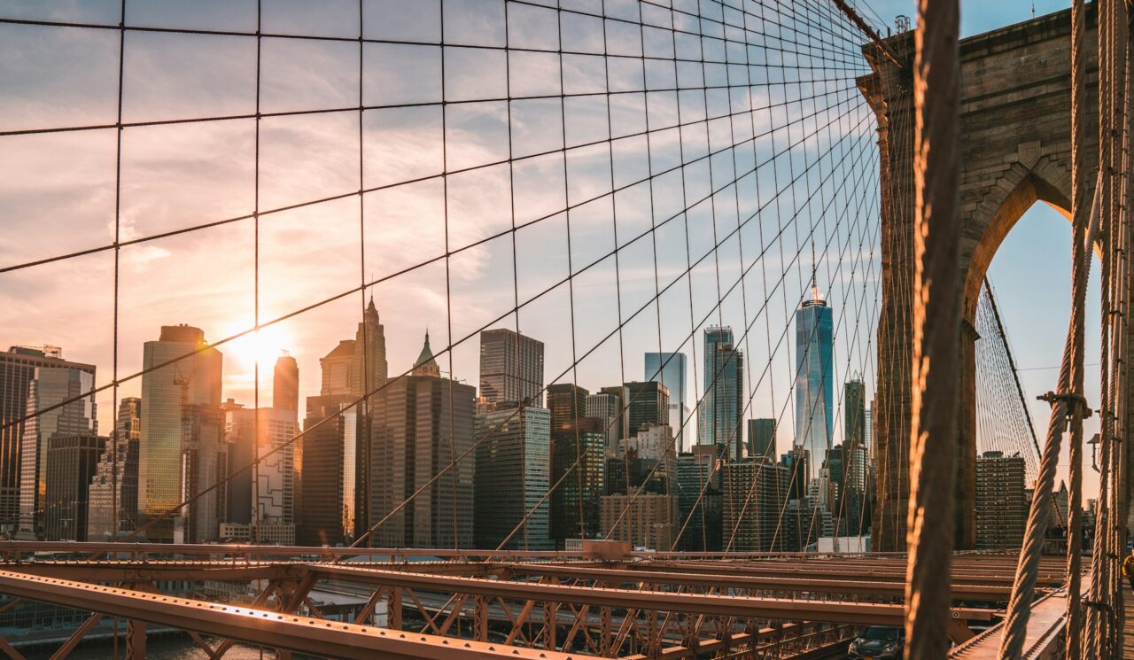 Close up of the Brooklyn Bridge and view of Manhattan skyscrapers.