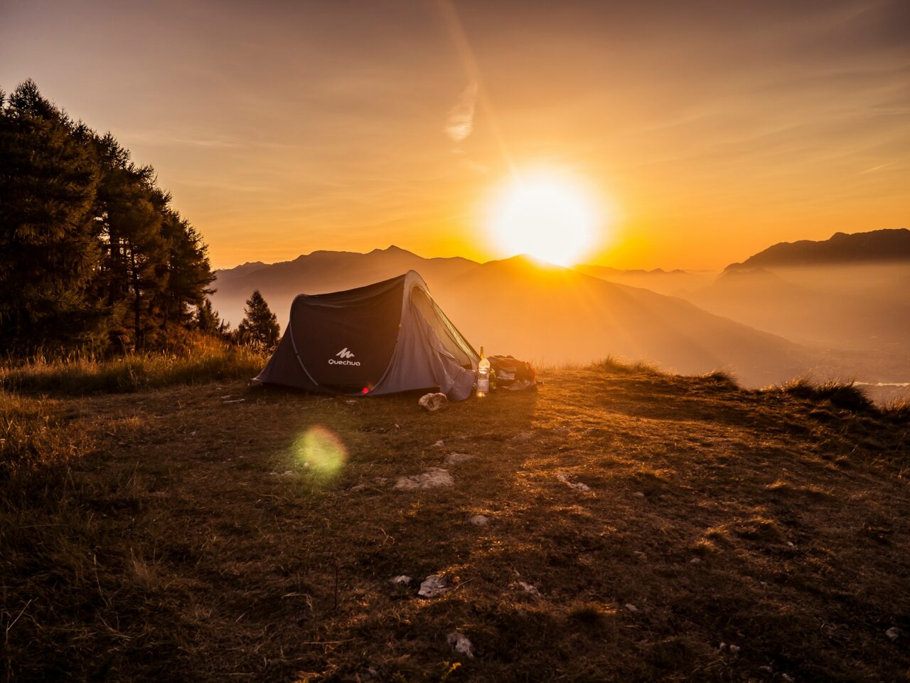 Tent with sun rising over the mountains