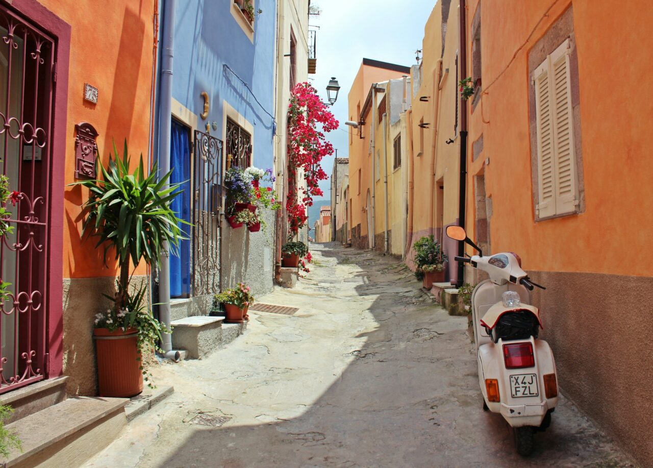 Colorful street in Italy with white motor scooter