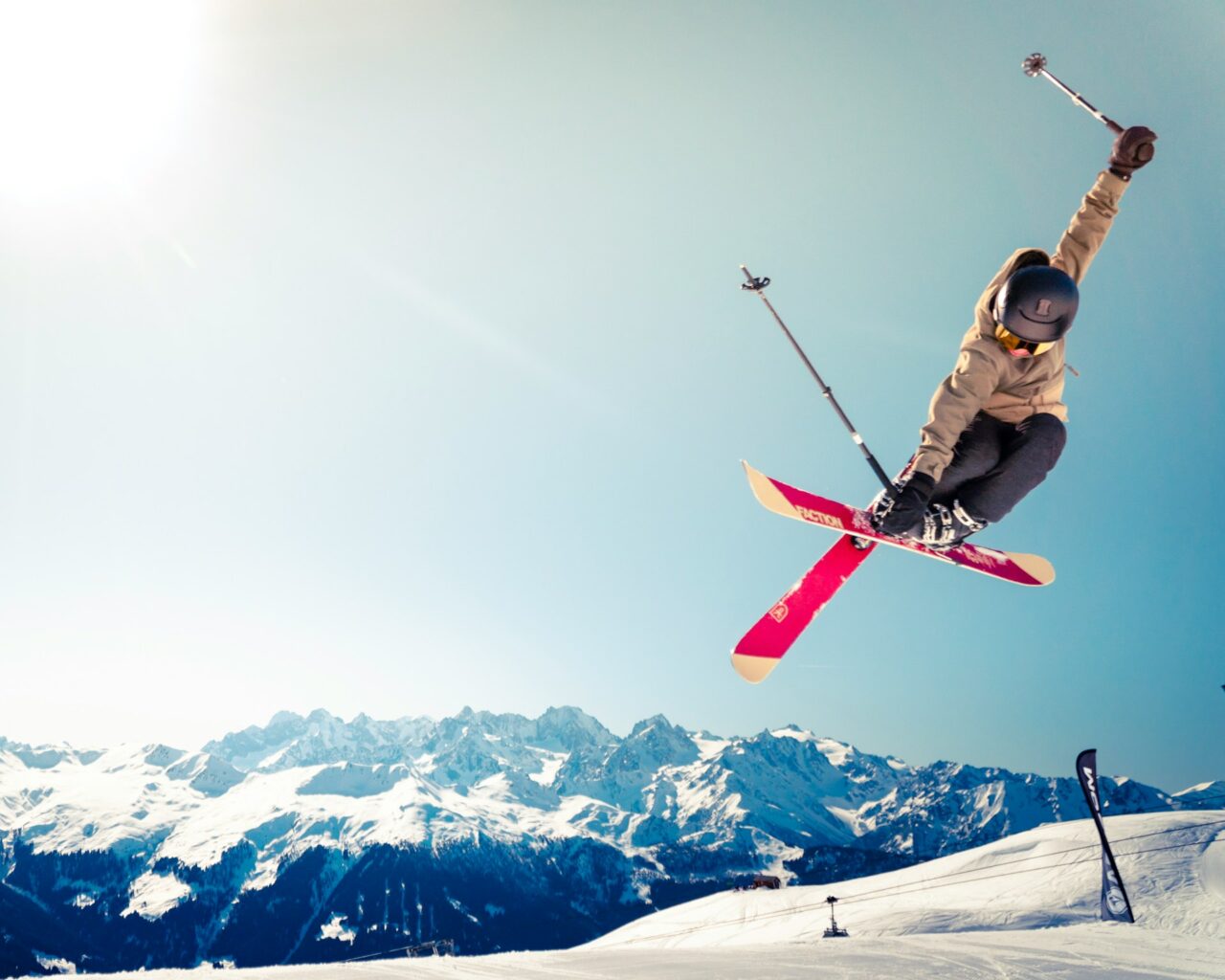 Woman on skis in the air on a mountain