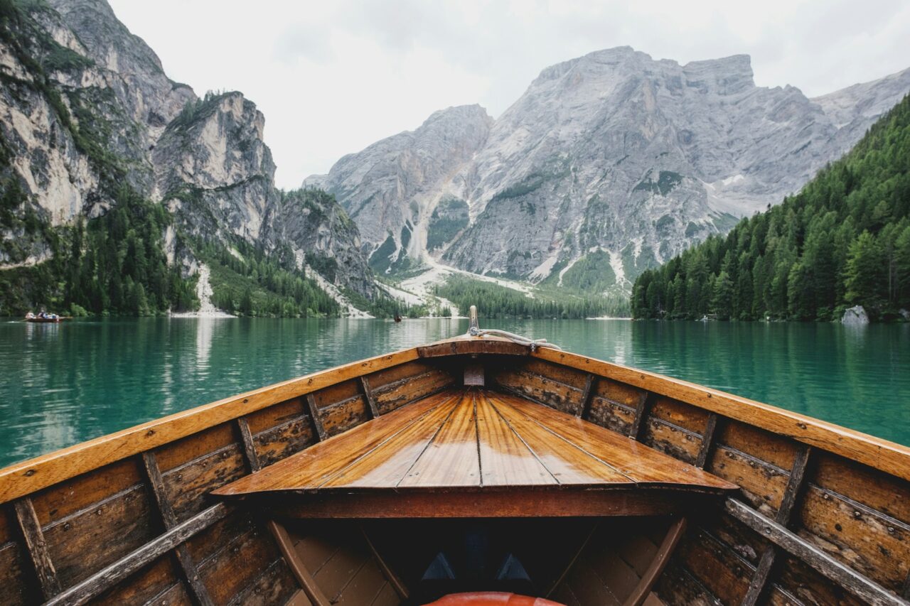 Wooden boat on a lake surrounded by mountains