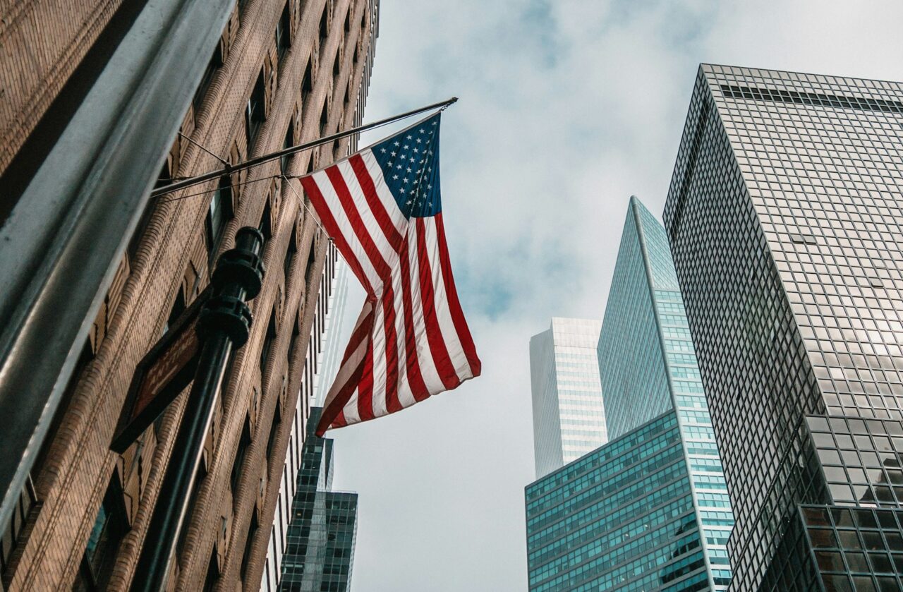 Close up of skyscrapers and the American Flag