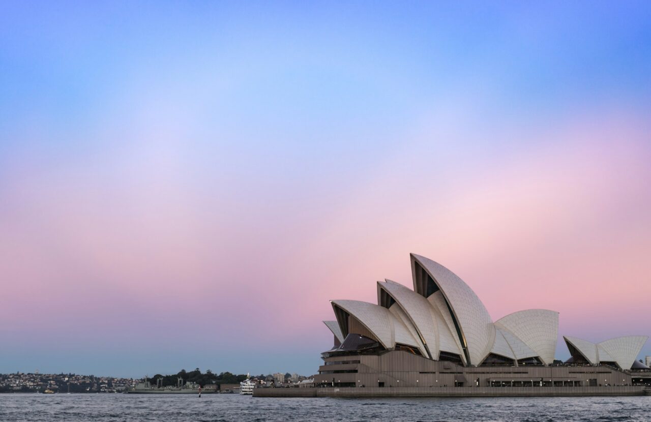 Sydney Opera House at sunset next to a pink sky