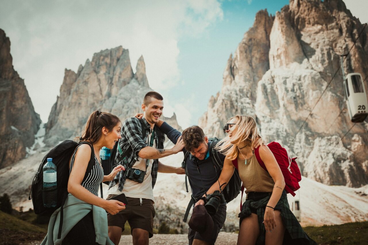 Group of people laughing on a hike in front of rock formations