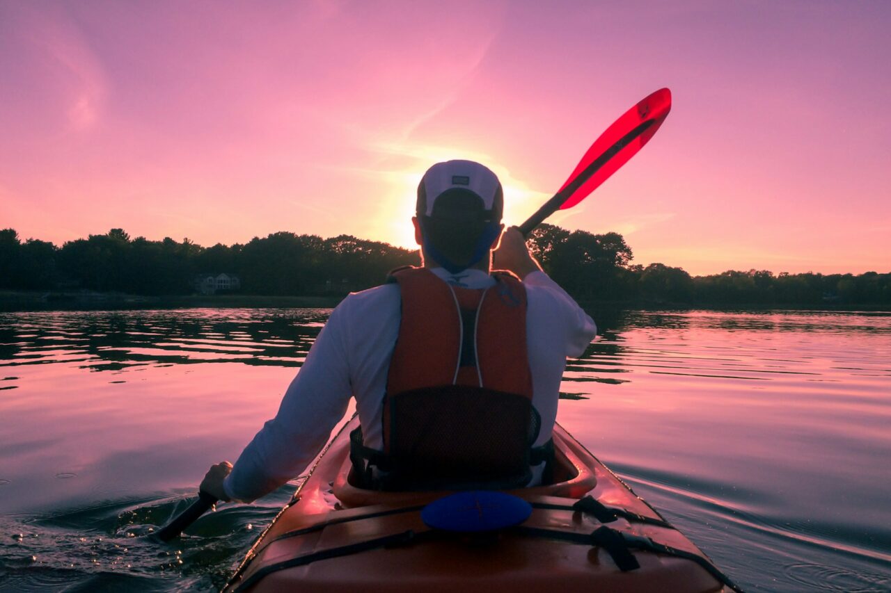 Man in kayak at sunset