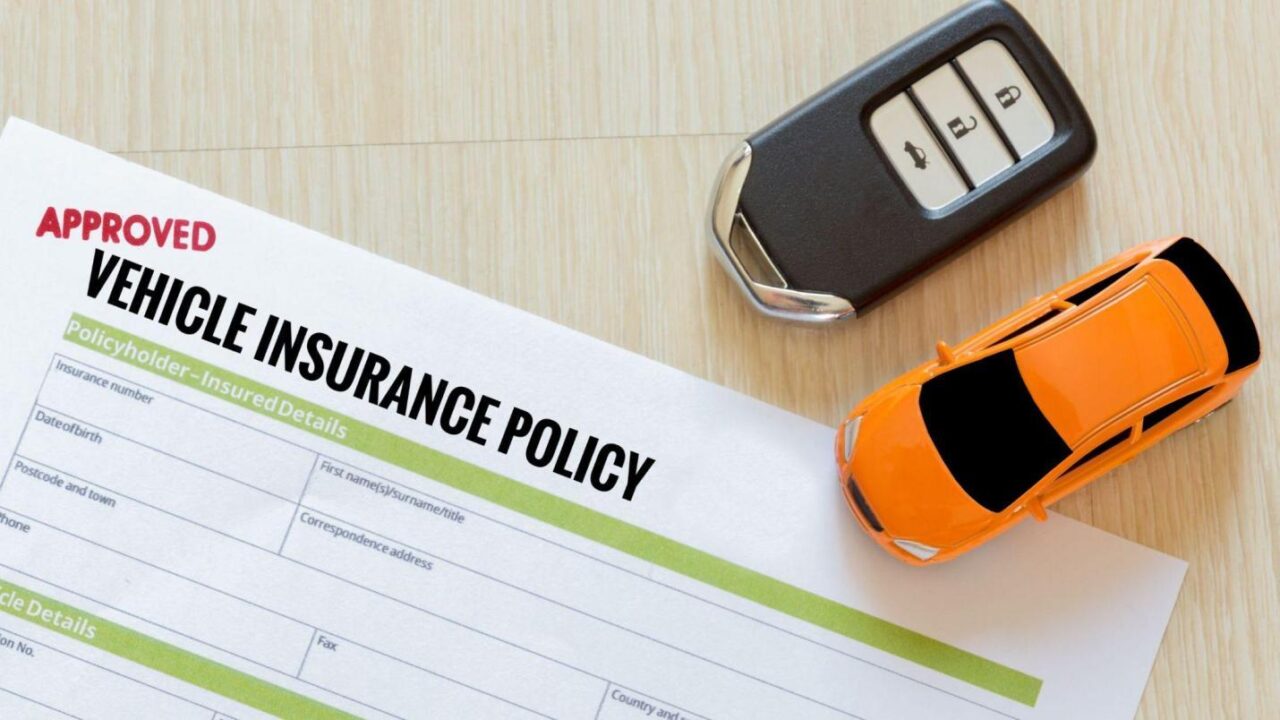 Vehicle insurance policy document with car keys and mini toy car