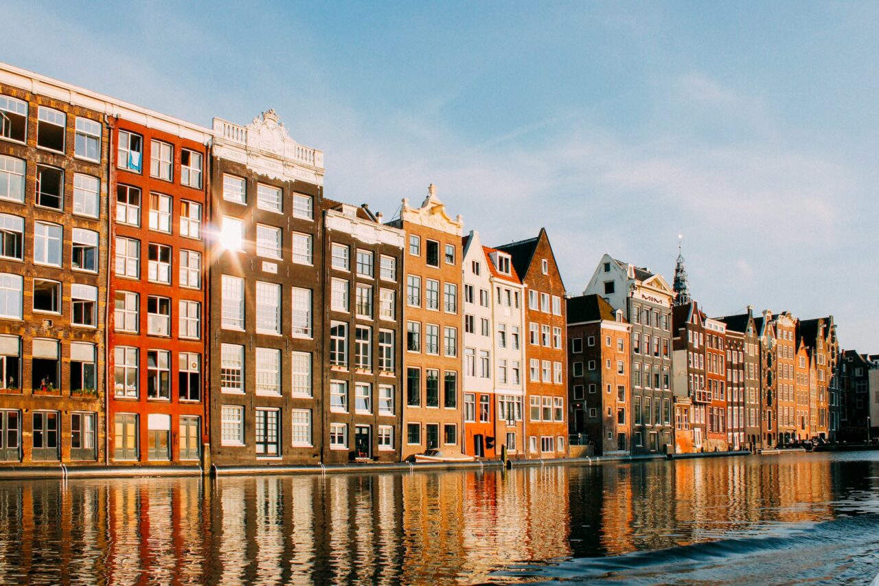 Colored buildings alongside a canal in Amsterdam