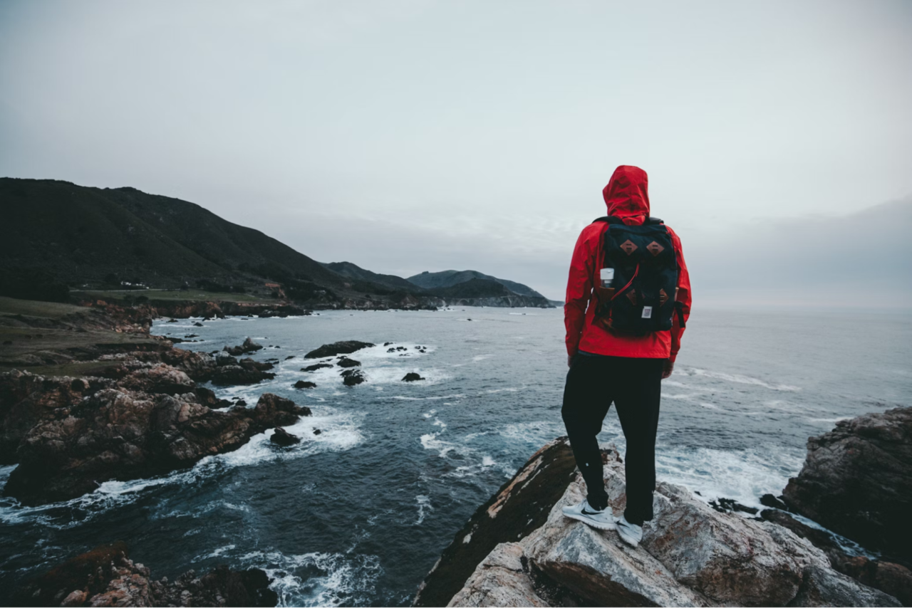 Person standing on rocks with a backpack on