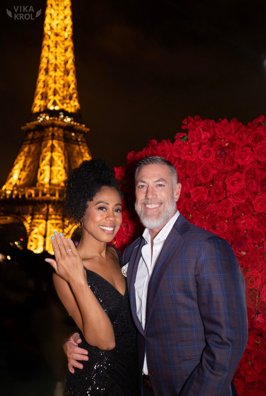 Engaged couple in front of the Eiffel Tower
