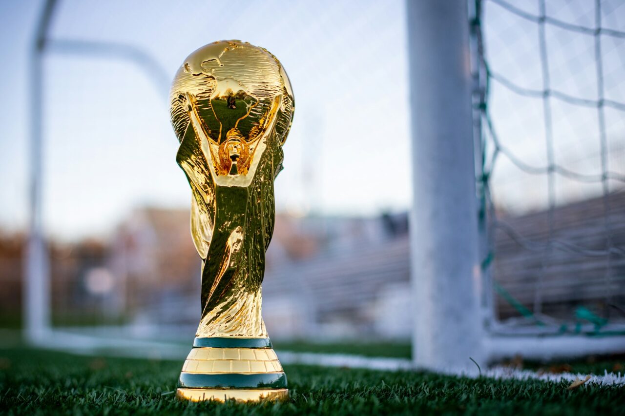 World Cup trophy next to a football net