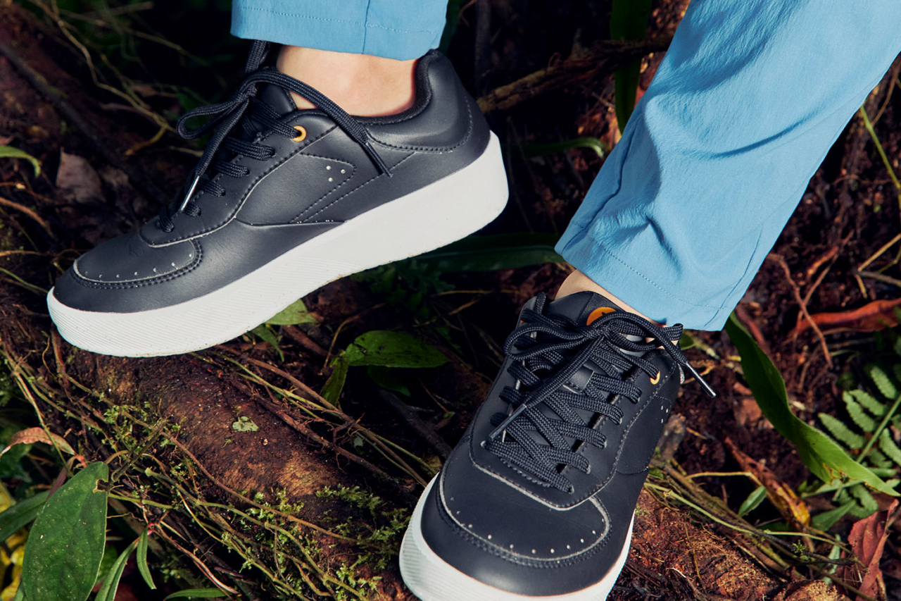 Close up of legs with black sneakers and blue trousers