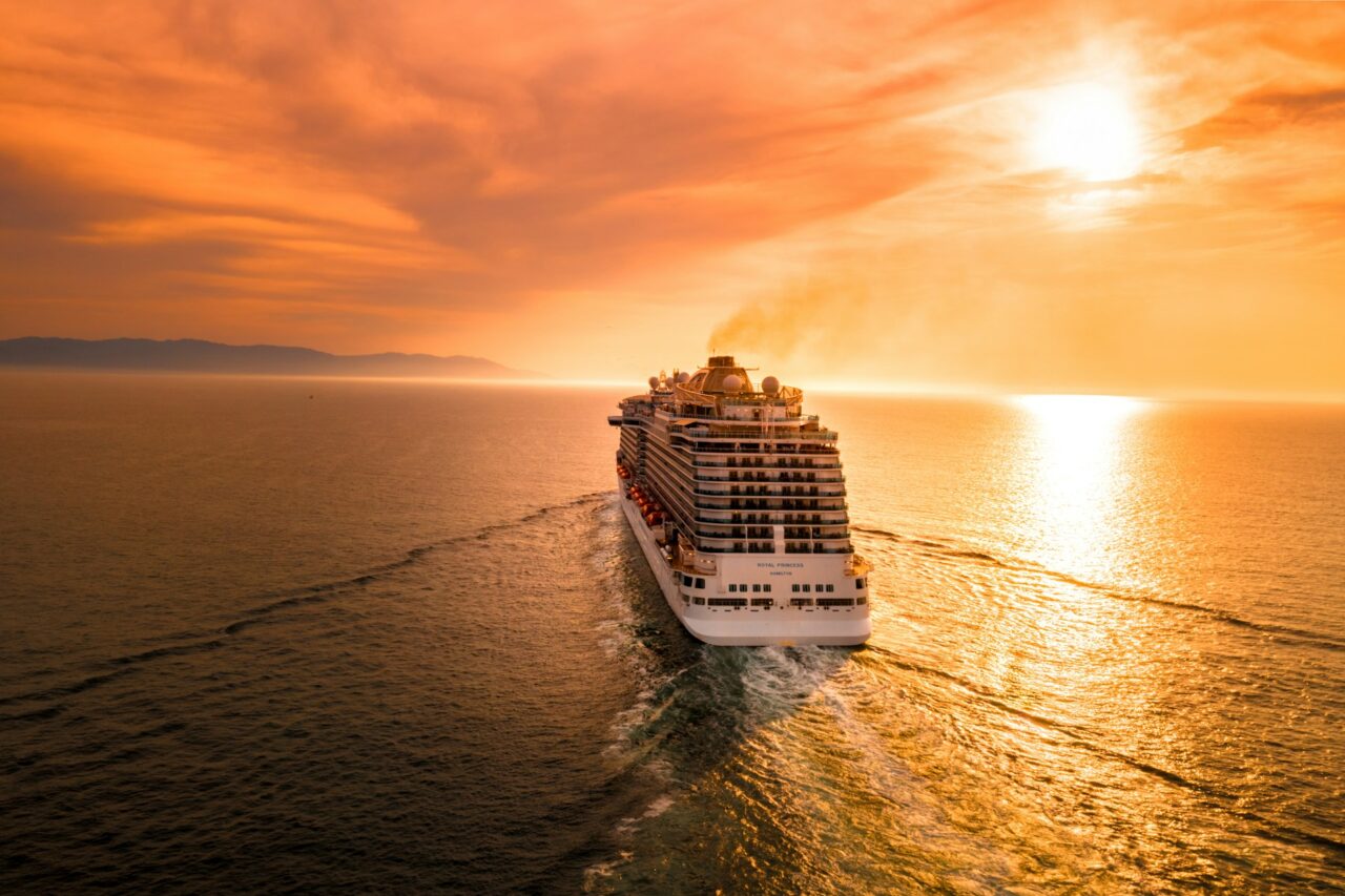 Cruise ship at sunset with orange sky