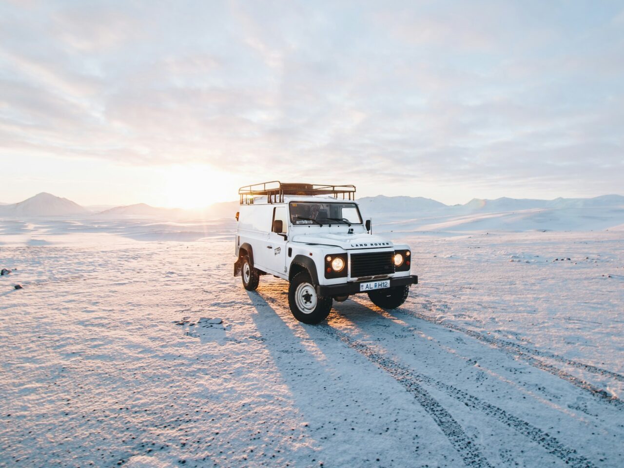 White Land Rover Defender on snowy background