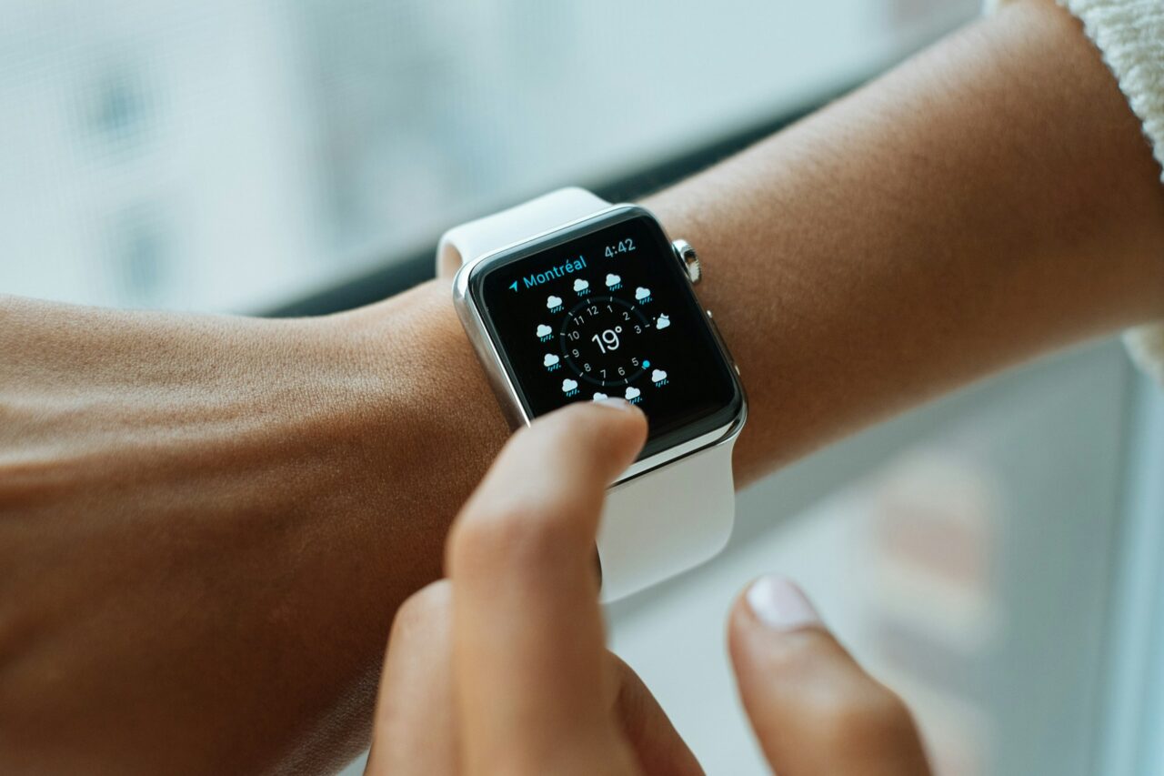 Woman's arm wearing an Apple Watch showing the weather