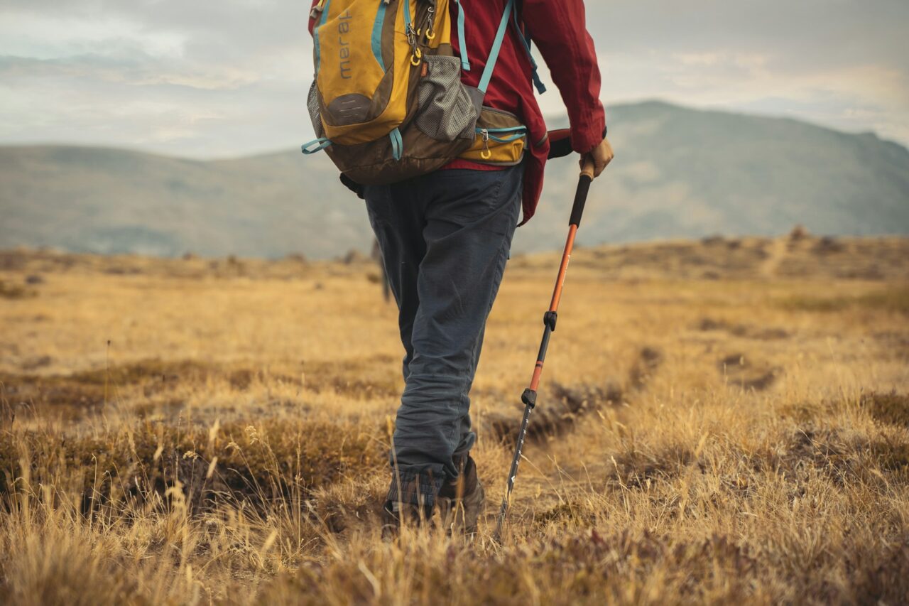 Close up of a hiker in a field with hiking gear