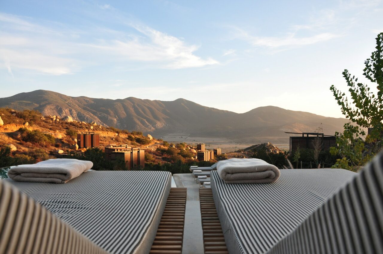 Striped lounge chairs overlooking the mountains at a luxury resort