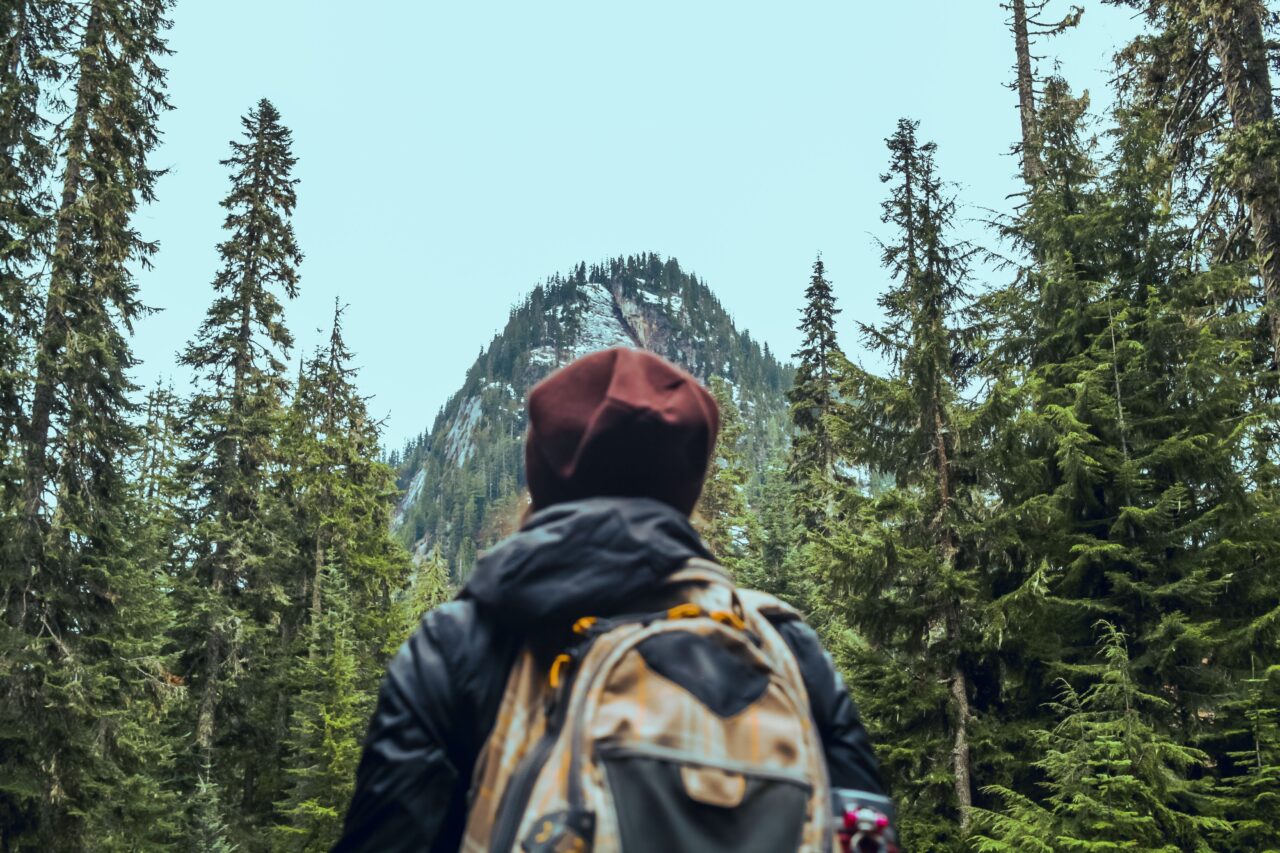 Person with backpack hiking through wilderness
