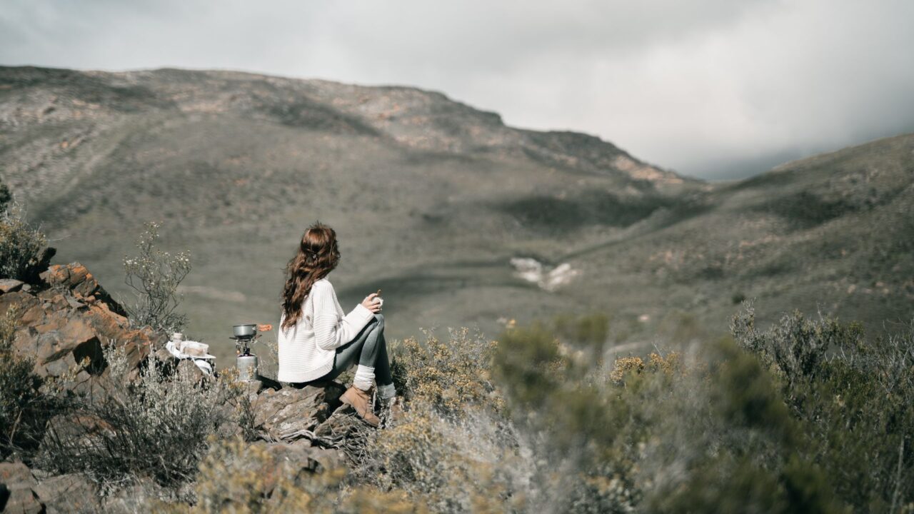 A woman enjoying a view of a mountainous landscape.
