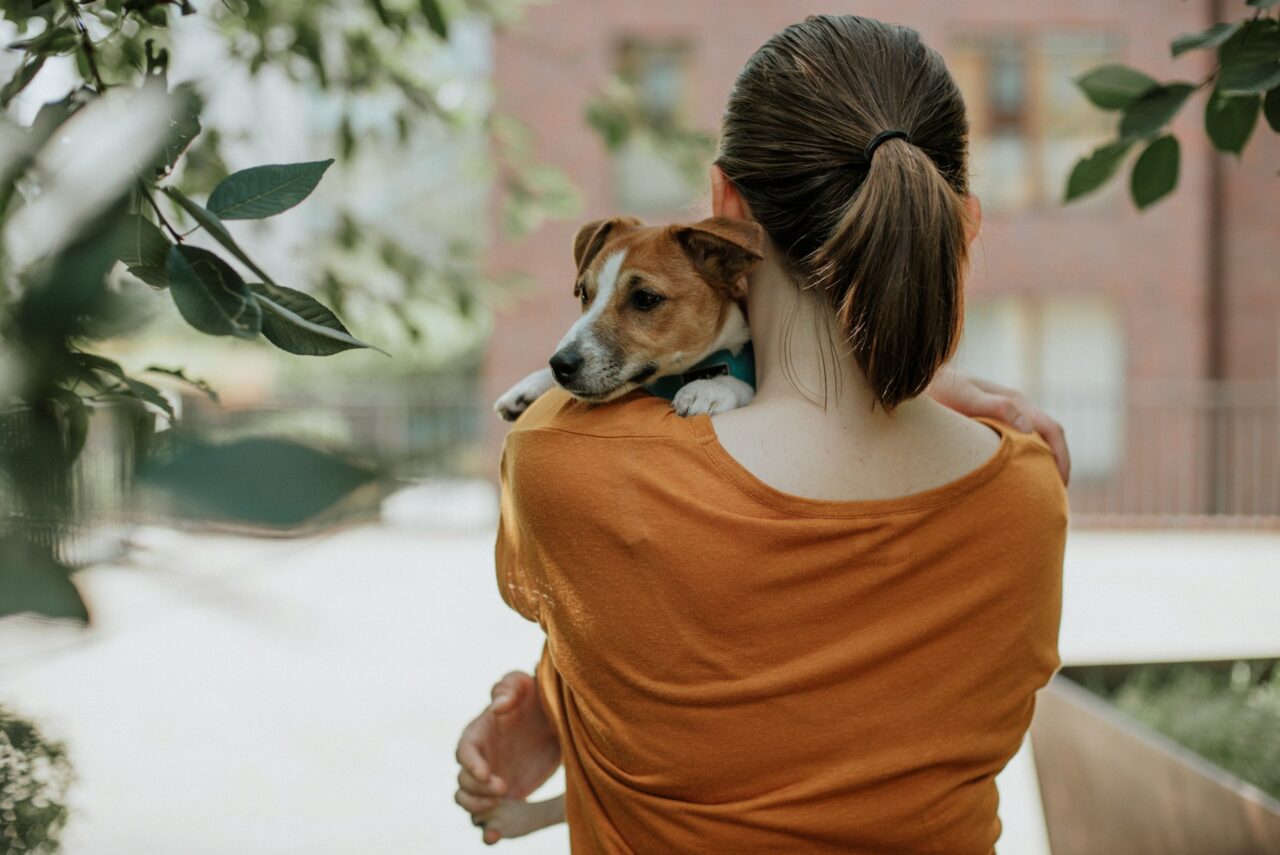 Woman hugging a small dog