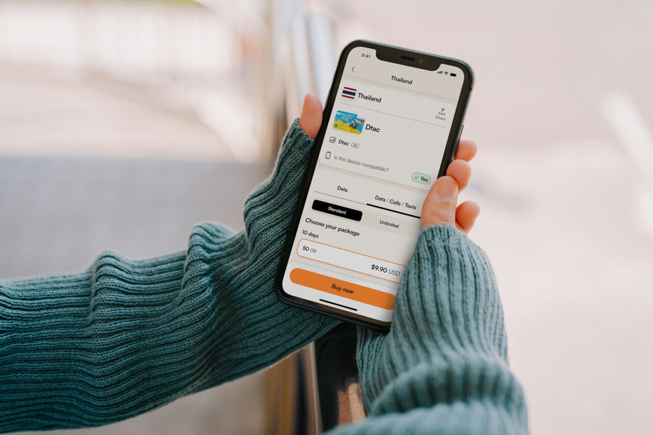 Hands holding a phone with esim app open