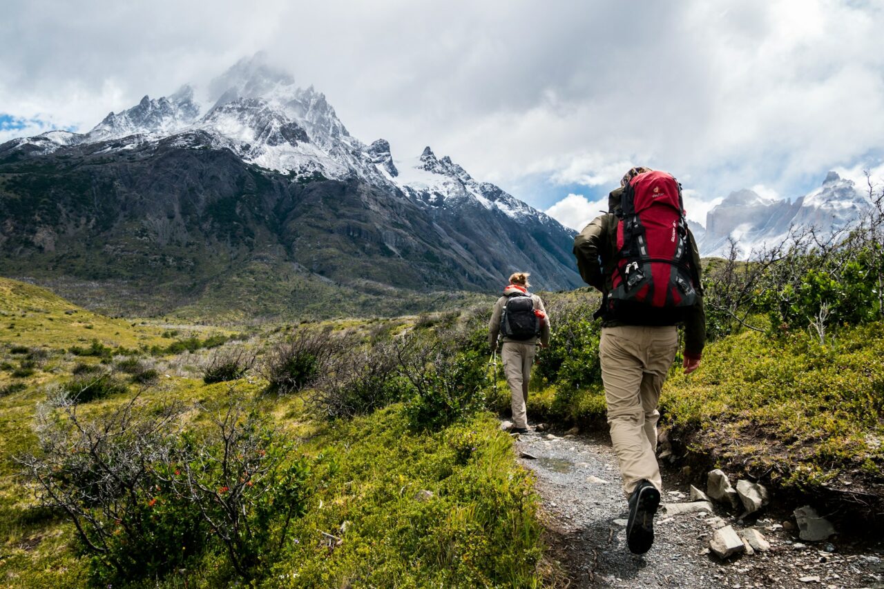 Hikers hiking on a trail with backpacks in Chile