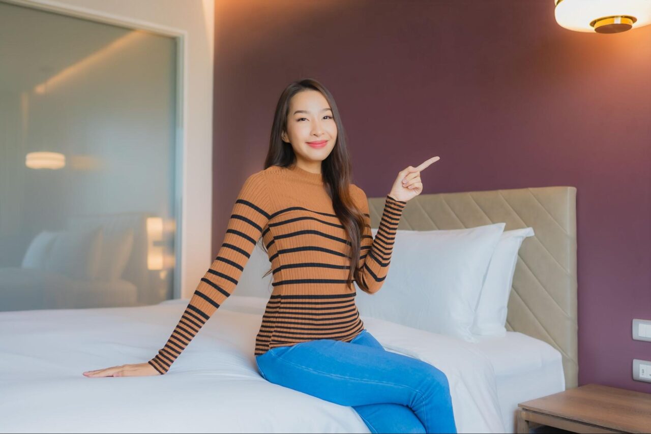 Woman sitting on a bed