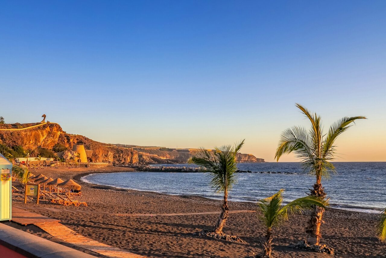 Dark sand beach in Tenerife with blue sky