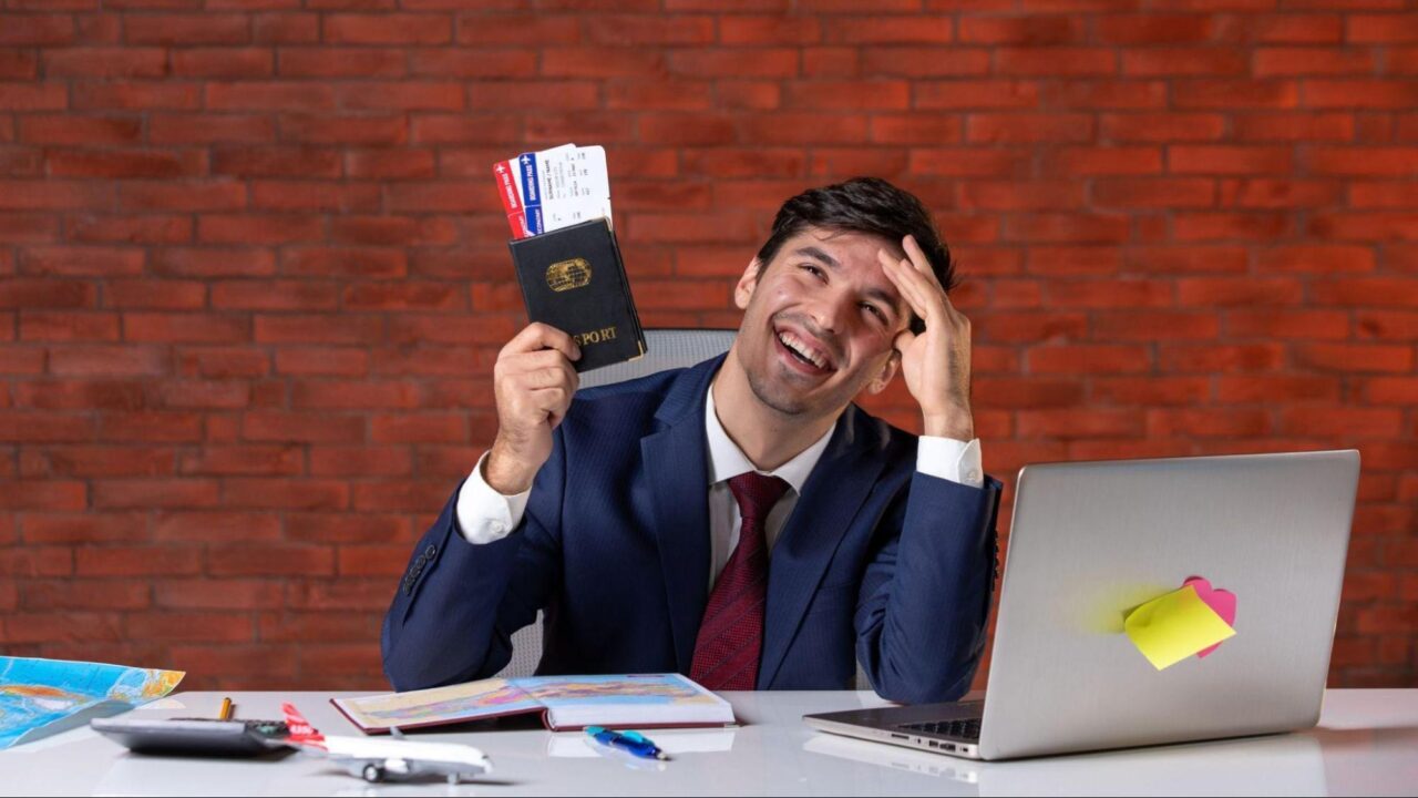 Man at a desk with passport in hand