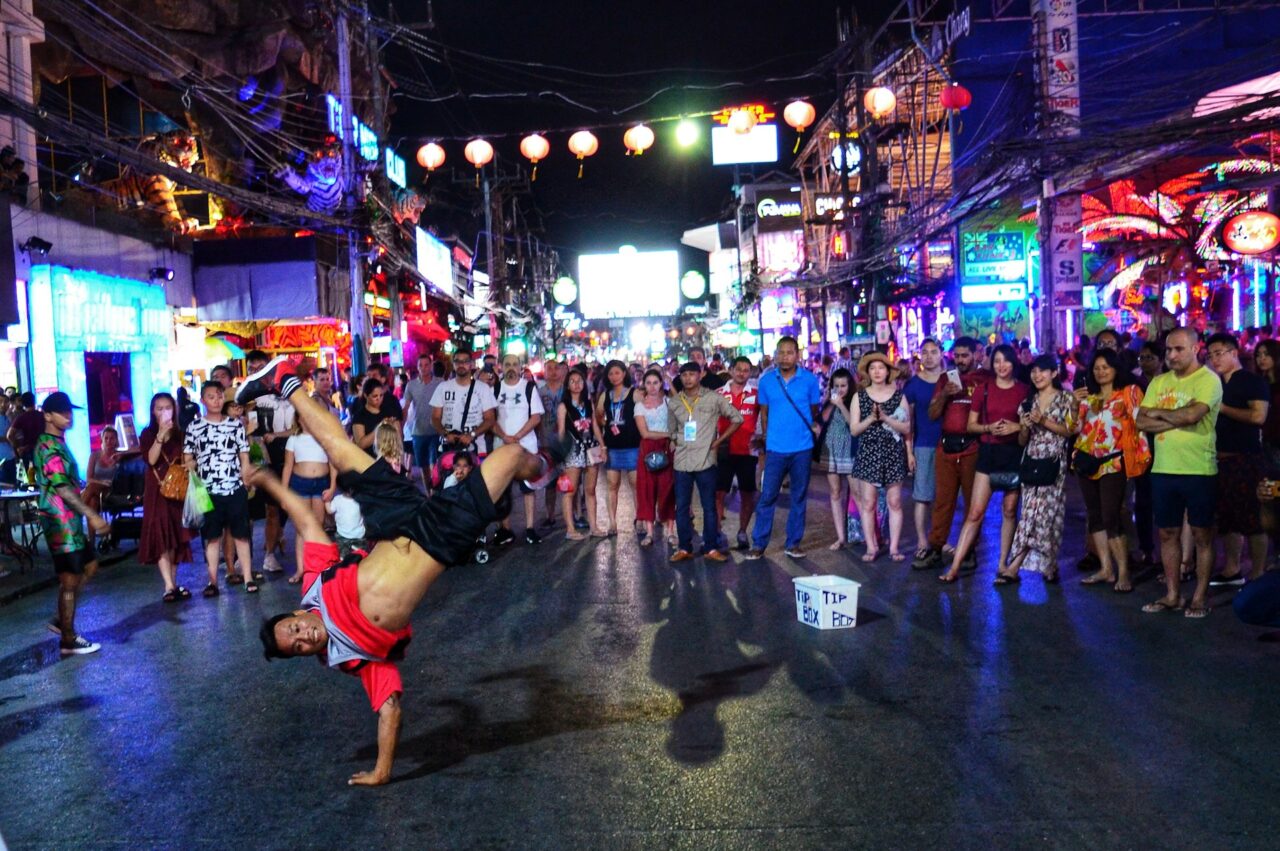 Group of people watching a street performer in Phuket at night